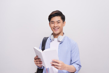 Confident asian handsome student holding books