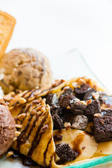 tasty pancakes with chocolate ice cream crispy waffle whipped cream with brownies cherry almond and chocolat syrup on top.served pancakes crepes on plate.sweets dessert brownies pancakes crepes.