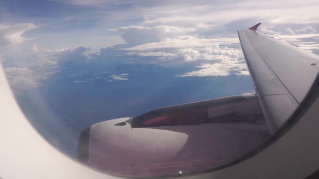 clouds & jet engine seen through the windows of planes