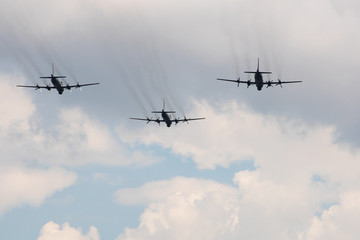 Fototapeta na wymiar Three large military aircraft with a jet stream