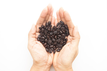 Roasted coffee beans on woman hands isolated on white background