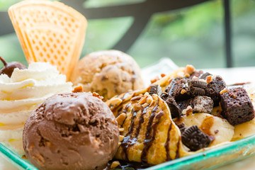 tasty pancakes with chocolate ice cream crispy waffle whipped cream with brownies cherry almond and chocolat syrup on top.served pancakes crepes on plate.sweets dessert brownies pancakes crepes.