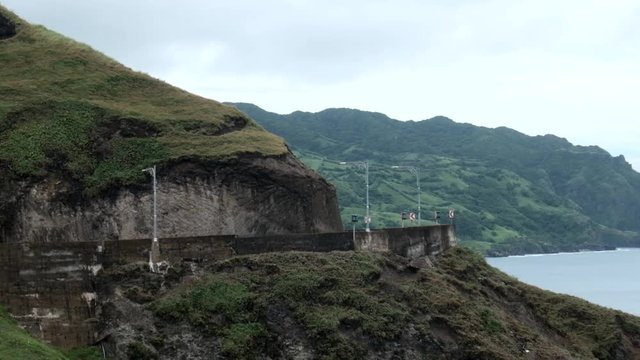 A narrow road beside a mountain. Located in Basco, Batanes in the Philippines.