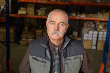 senior worker portrait in warehouse