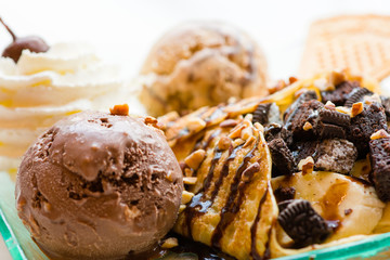 tasty pancakes with chocolate ice cream crispy waffle whipped cream with brownies cherry almond and chocolat syrup on top.served pancakes crepes on plate.sweets dessert brownies pancakes crepes.