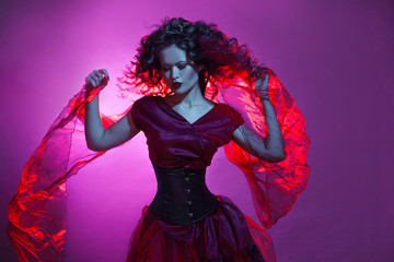 Fototapeta premium Goth girl. Woman in red dancing.