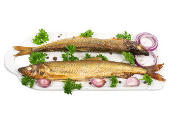 smoked smelt on white cutting board isolated on white background