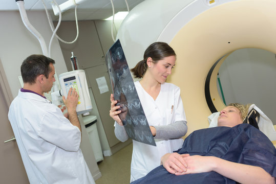 doctor preparing female patient for mri scan in hospital