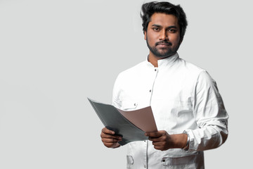 experienced doctor from India holding folder and documents. hardworking Hindoo doctor. copyspace....