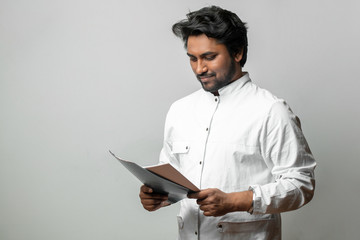 young doctor looking at the resalts of tests. cheerful student reading report at the medical...
