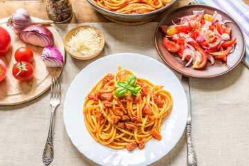 Traditional Italian lunch - Pasta Ammatricana and salad