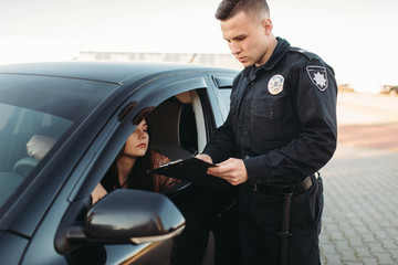 Cop in uniform checks license of female driver