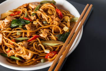 wok stir-fry egg noodles with fried chicken and thai spices and, traditional spicy asian cuisine food