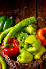 various harvested peppers and hot peppers in basket