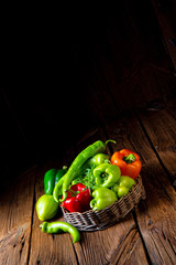 various harvested peppers and hot peppers in basket