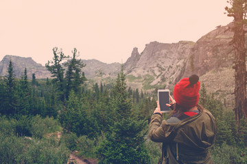 Fototapeta na wymiar woman using phone in the mountains