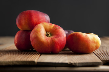 Peaches and Nectarines fruits. Concept for healthy nutrition. Dark black background and wooden table. Isolated.