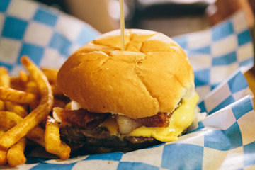 burger and fries on checkered blue and white paper