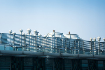 Air compressor on the Building office in city with blue sky background.