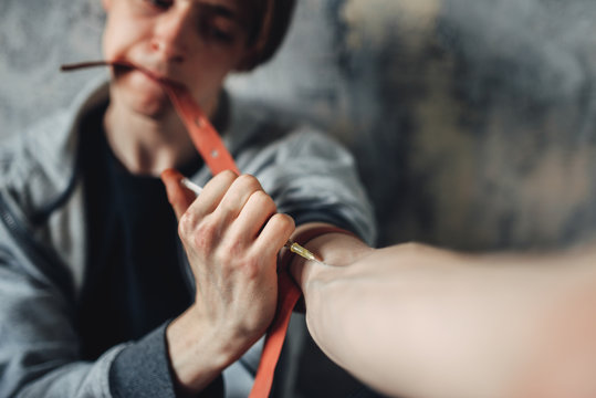 Male junkie with syringe doing an injection dose