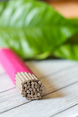 Incense sticks. Green leafs background. Burning incense sticks are used for meditation