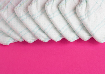 Baby diapers on a pink background, diaper