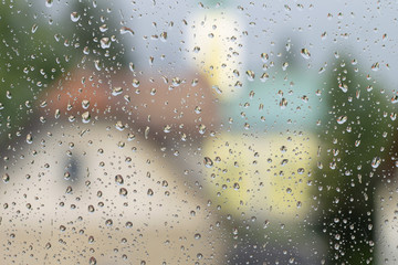 Cityscape through the rainy glass window