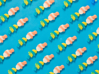 Fototapeta na wymiar Fish kissing jelly candies pattern on blue background