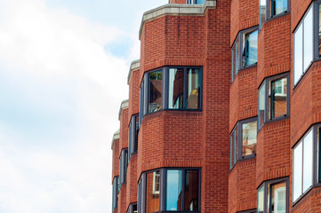 Fragment  of red brick modern building against a sky