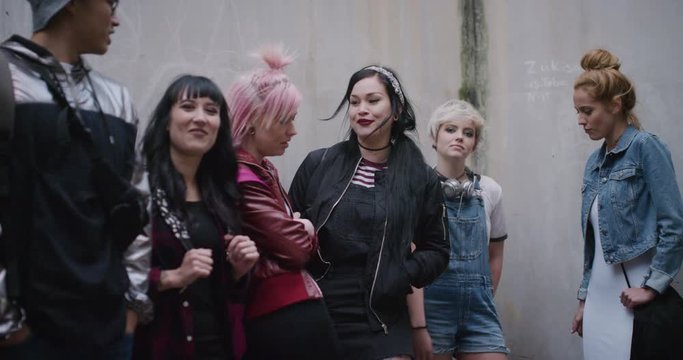 portrait group of multi ethnic friends talking enjoying chatting together socializing young college students wearing stylish urban fashion human individuality slow motion