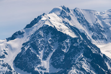 Obraz premium Mountain peaks covered with white shiny snow.