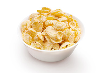 Bowl full of corn flakes on white background