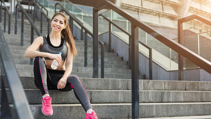 Gorgeous young fit woman sitting on stairs