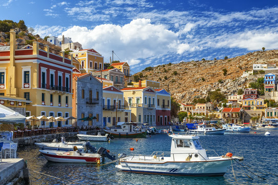 Scenic waterfront on the Greek island of Symi with bright and colorful fishing boats