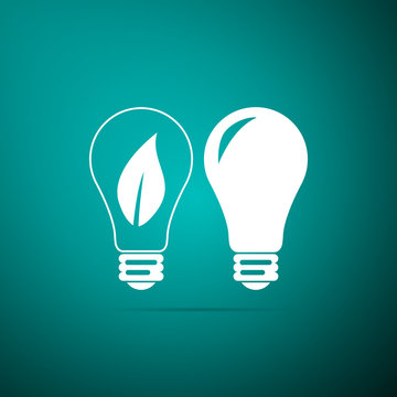 Classic Lamp and Light bulb with leaf inside icon isolated on green background. Lighting electric lamp. Green eco energy concept. Flat design. Vector Illustration