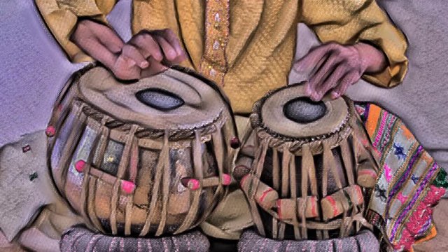  close up of hands of amazing indian percussion musician performing with tabla with overlayed abstract paint effect
