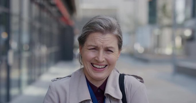 portrait happy mature business woman laughing excited enjoying successful urban lifestyle cheerful middle aged female in city having fun slow motion