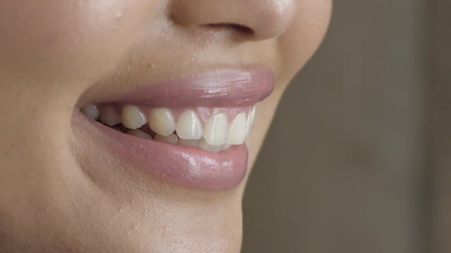 close up woman lips smiling happy wearing glossy lipstick showing healthy teeth dental health concept