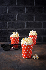 Popcorn with 3d glasses on dark background