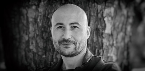 guy is smiling. Monochrome portrait of a bald bearded man.