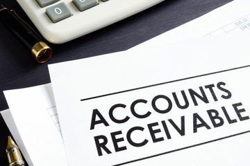 Documents about Accounts receivable, pen and calculator.