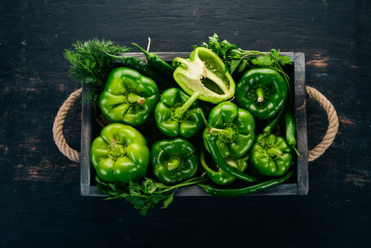 Fresh Green Pepper In A Wooden Box. Organic Food. Top View. Free Space For Text.