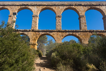 Fototapeta premium Roman aqueduct in city of Taragona in summer