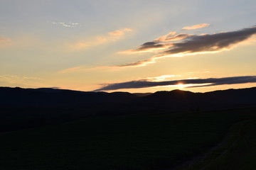 The sun setting in the mountains
