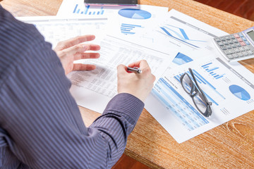 business man analyzing graph and chart document report