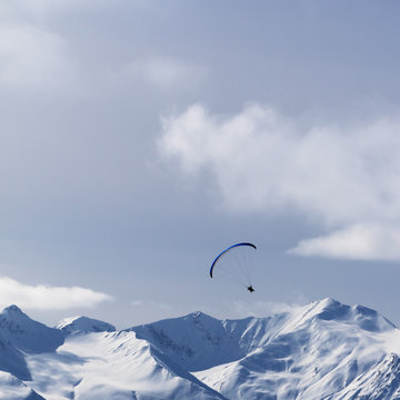Sky gliding in winter mountains