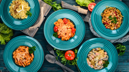 Pasta Set of Italian pastes. On a wooden background. Top view. Copy space.