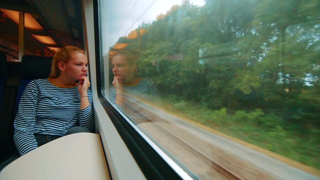 Clip of a girl sitting on a train, in front of the window, Netherlands.