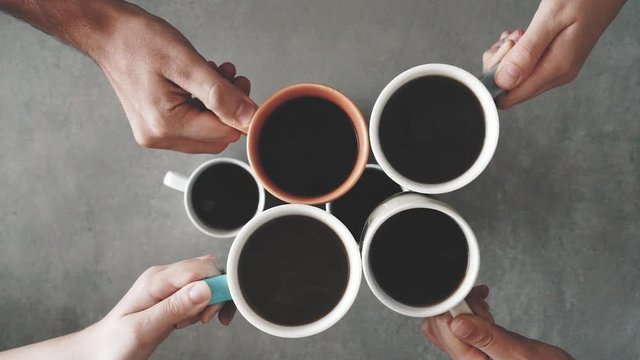 Group of friends hands holding cup of coffee