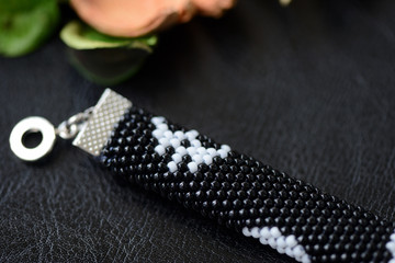 Beaded bracelet with a skull print on a dark background close up
